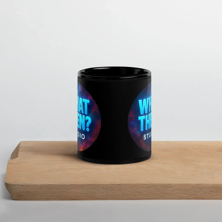 Black glossy mug with What Then Studio logo, on wooden tray, sci-fi giftware