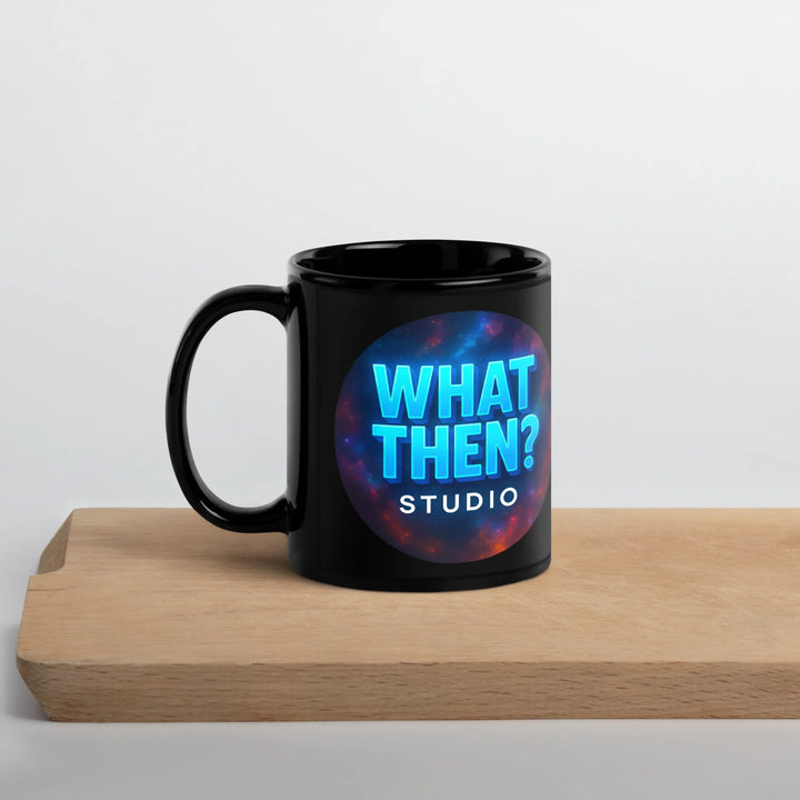 Black glossy mug with blue 'What Then? Studio' logo, on a wooden board, sci-fi theme.