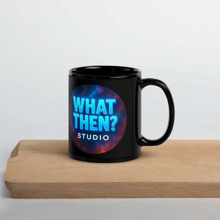 Black glossy mug with 'What Then? Studio' logo on wooden board, for sci-fi and mystery fans.