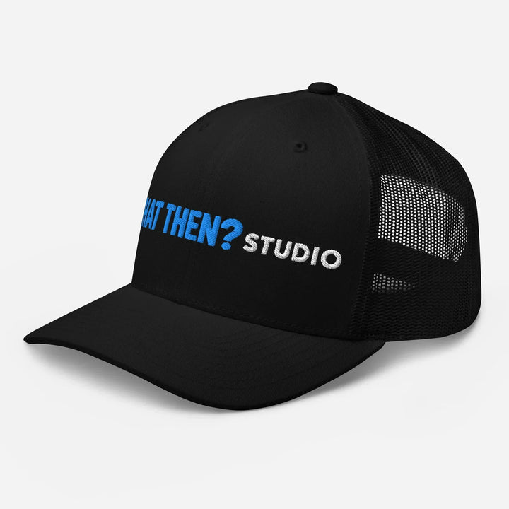 Black mesh retro trucker hat with blue 'WHAT THEN? STUDIO' logo on front, left side view