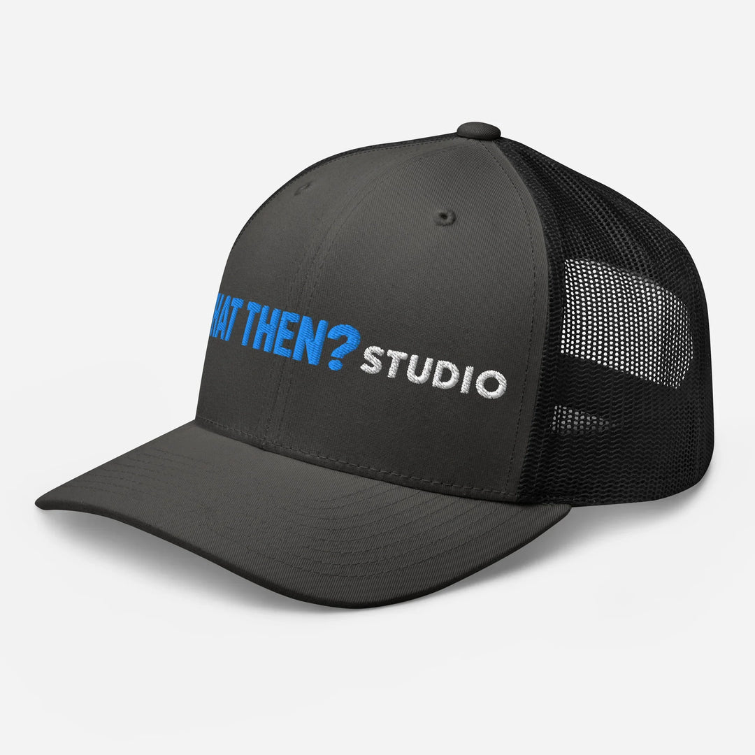 Charcoal and black retro trucker hat with 'What Then? Studio' logo, mesh back, front view.