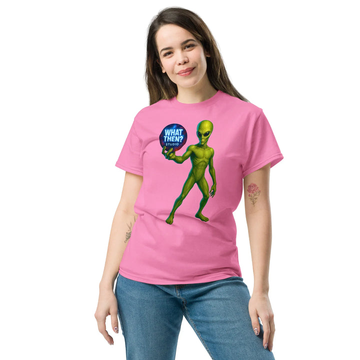 Woman in pink What Then Studio t-shirt with green alien graphic and blue speech bubble logo