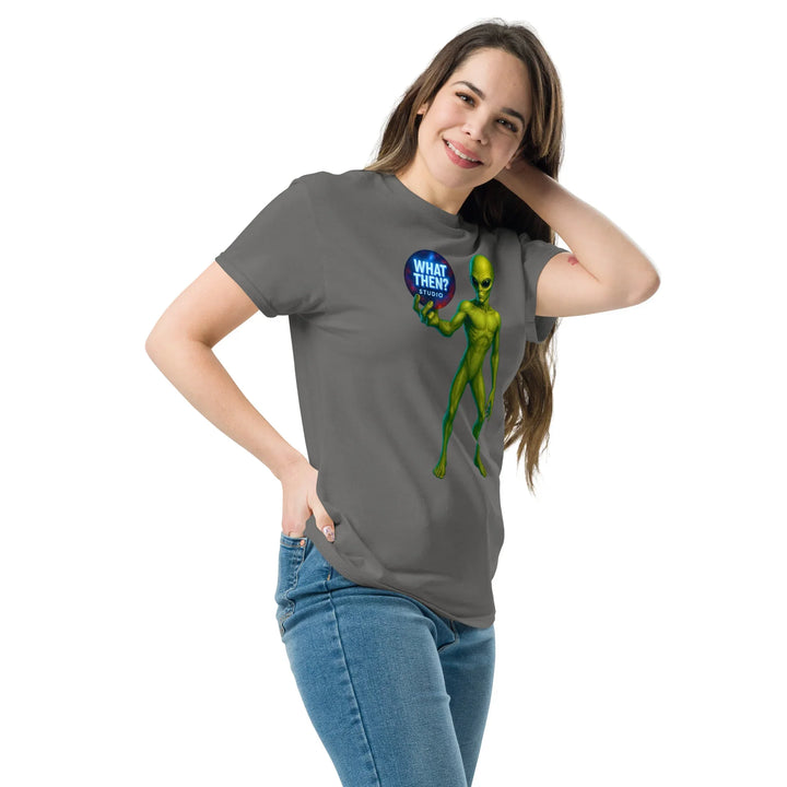 Woman wearing charcoal unisex tee with green alien and What Then Studio logo graphic