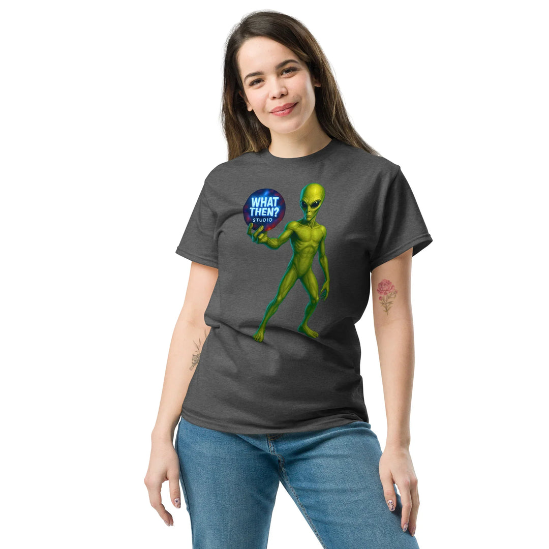 Woman wearing a dark heather unisex t-shirt with green alien and What Then Studio logo