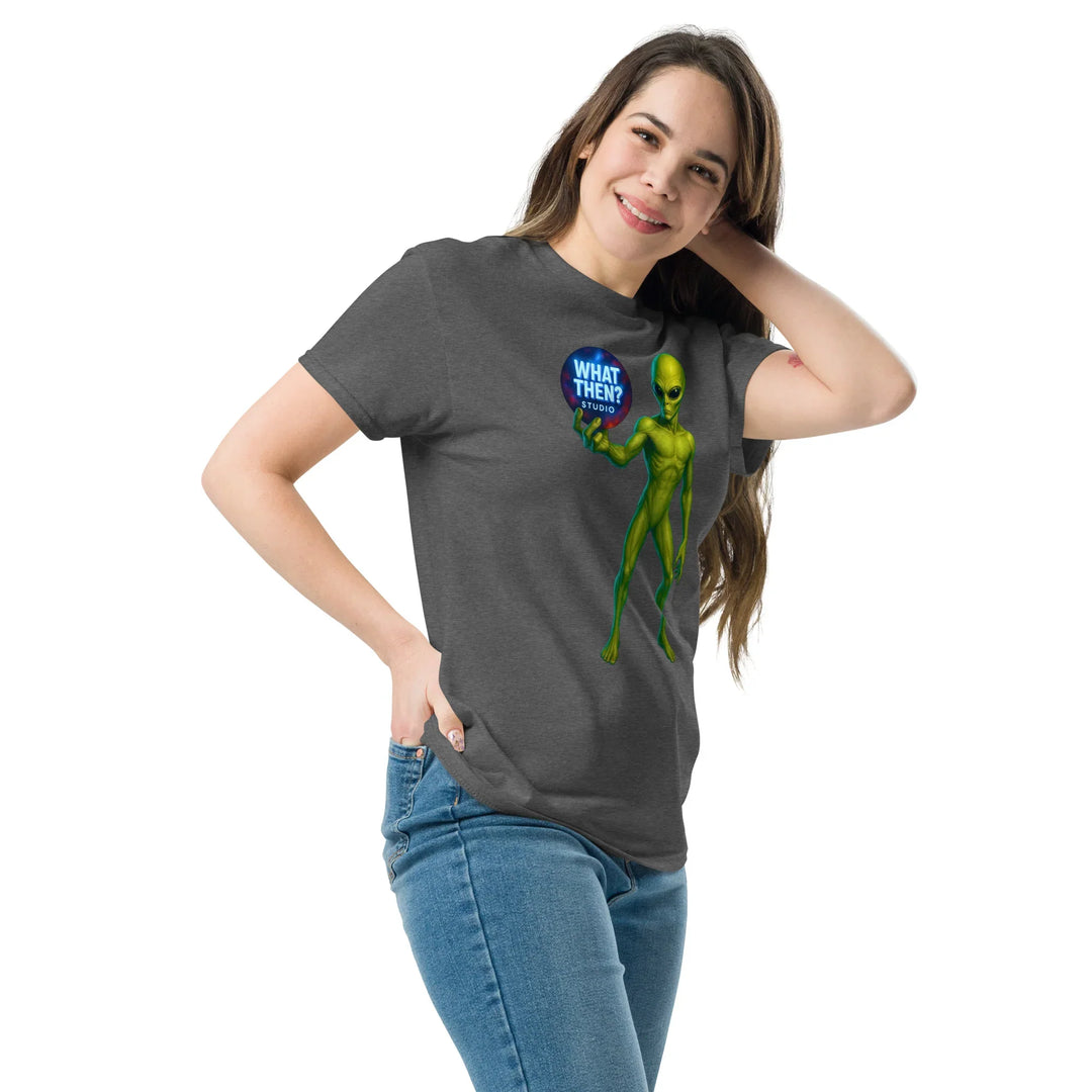 Woman wearing a dark heather t-shirt with green alien and 'What Then? Studio' logo graphic