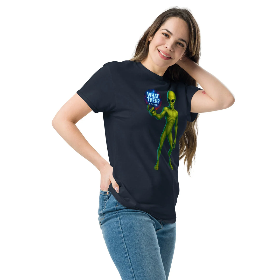 Woman models navy unisex t-shirt with green alien and 'What Then? Studio' text graphic.
