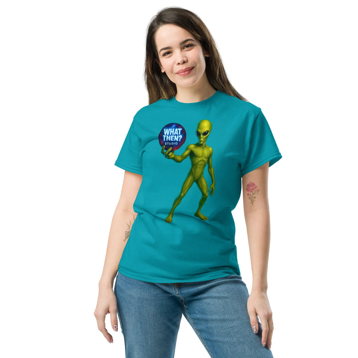 Woman wearing tropical blue What Then Studio t-shirt with green alien graphic and logo