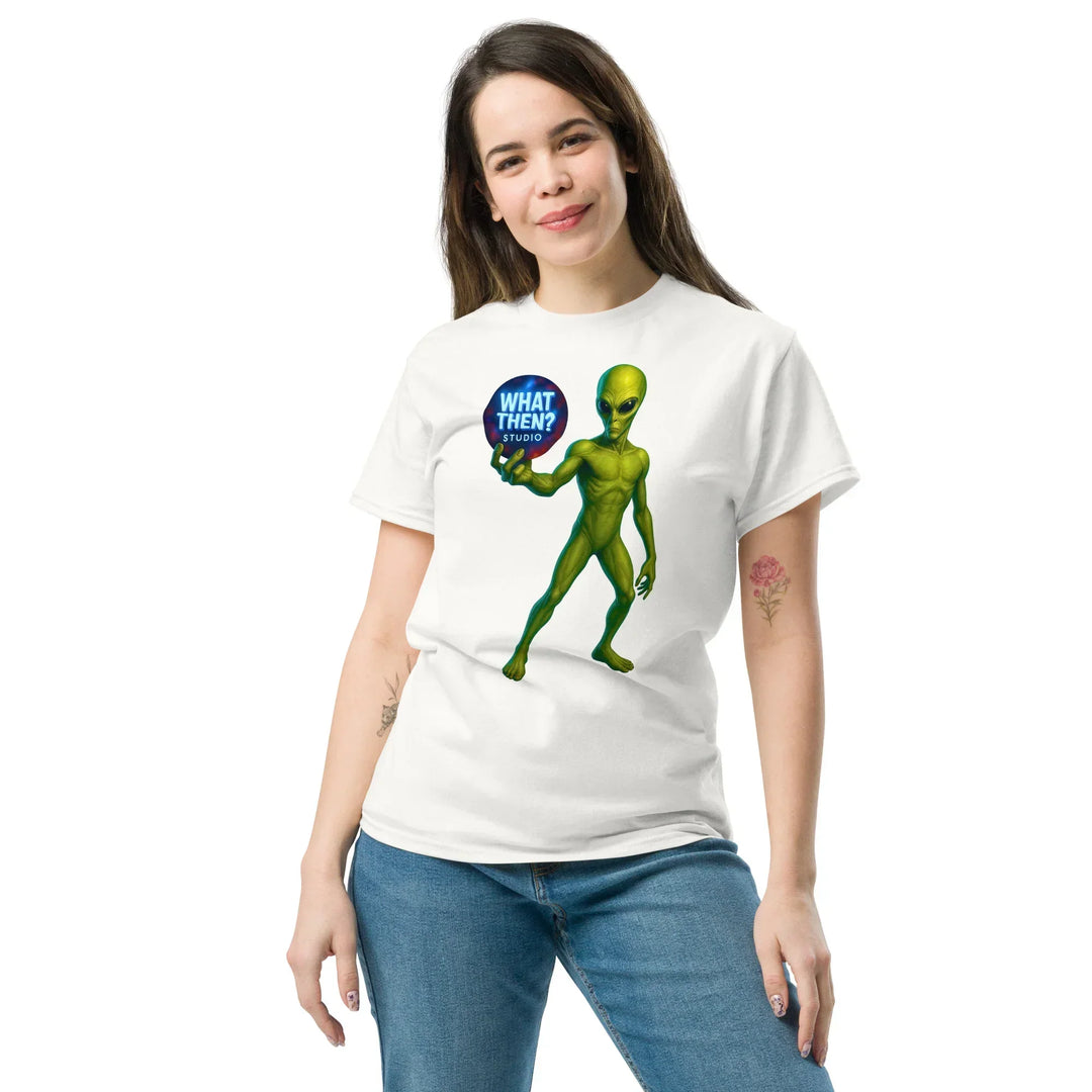 Woman wearing a What Then Studio white tee featuring a green alien graphic holding a logo orb.