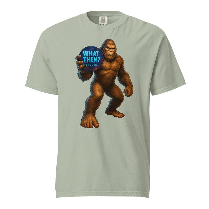 Unisex heavyweight t-shirt with Bigfoot holding 'What Then? Studio' logo graphic on front.