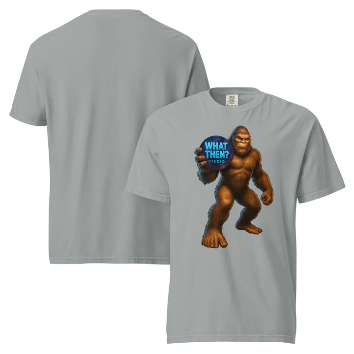 Granite unisex heavyweight t-shirt with Sasquatch holding 'What Then? Studio' blue logo on front