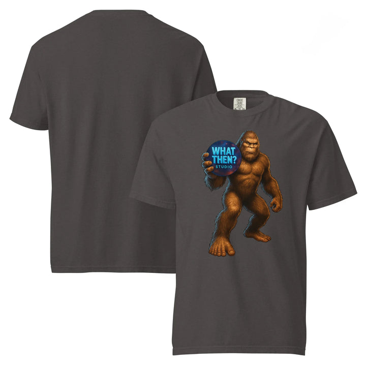 Unisex graphite heavyweight t-shirt featuring Bigfoot holding 'What Then? Studio' logo on front