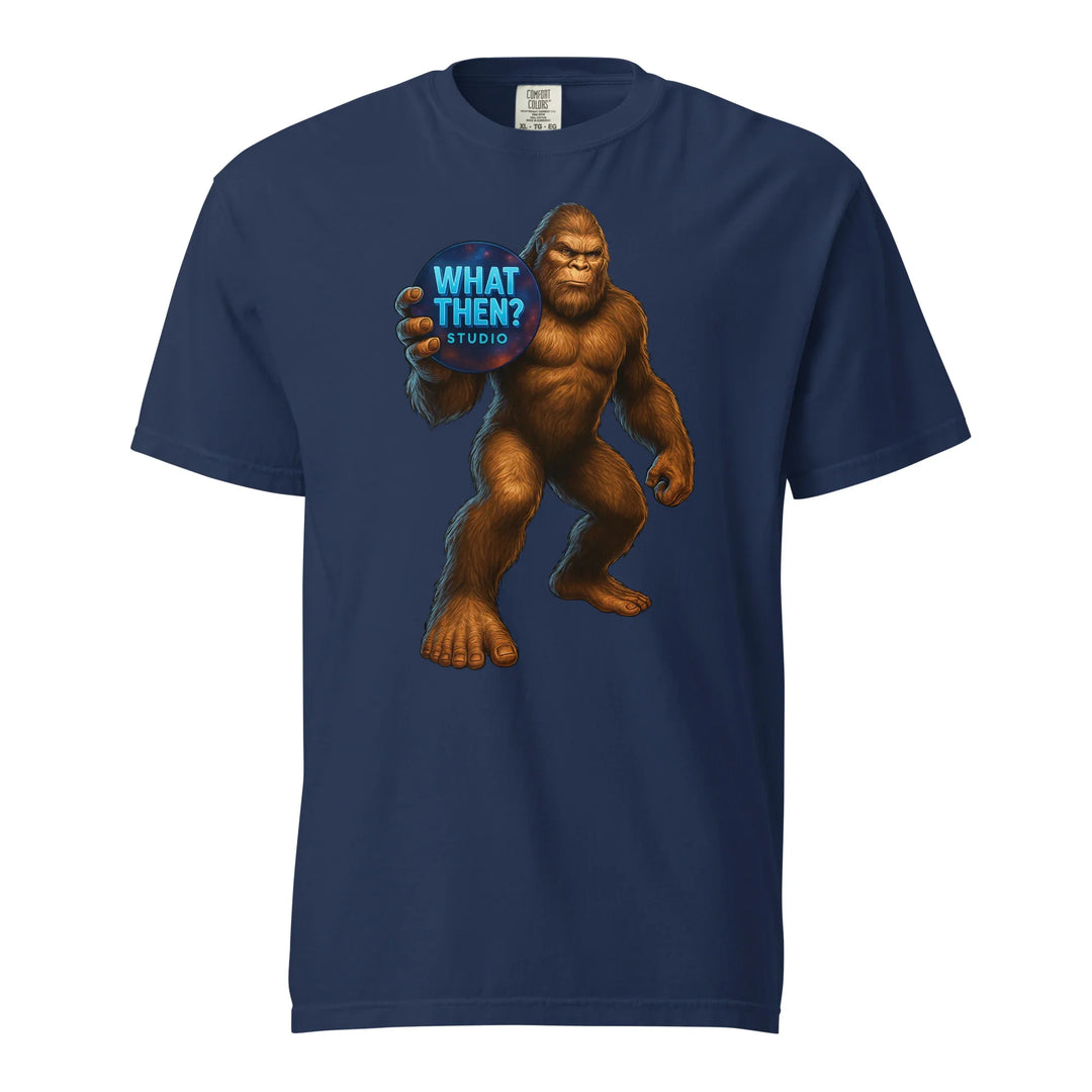 Unisex navy t-shirt with Bigfoot holding 'What Then? Studio' logo, What Then Studio merch