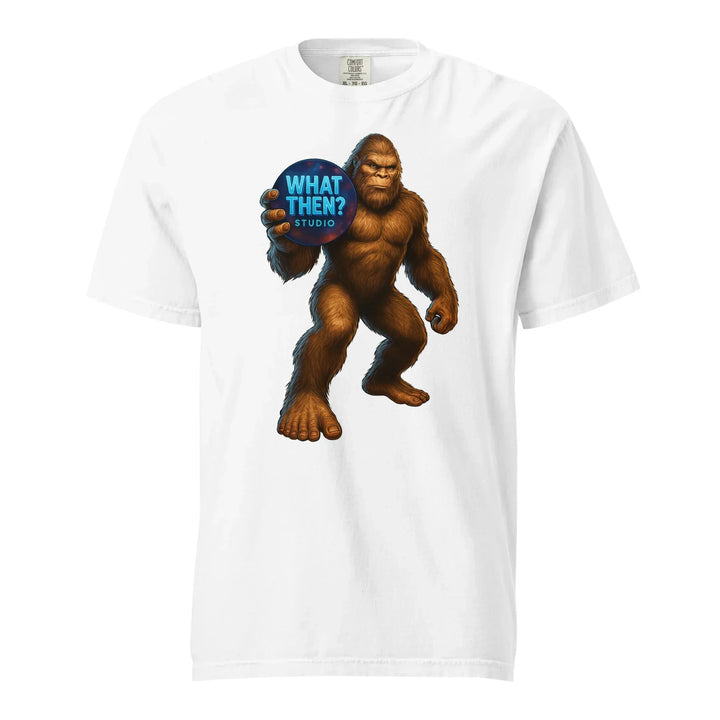 White heavyweight unisex t-shirt featuring Bigfoot holding a 'What Then? Studio' logo orb.